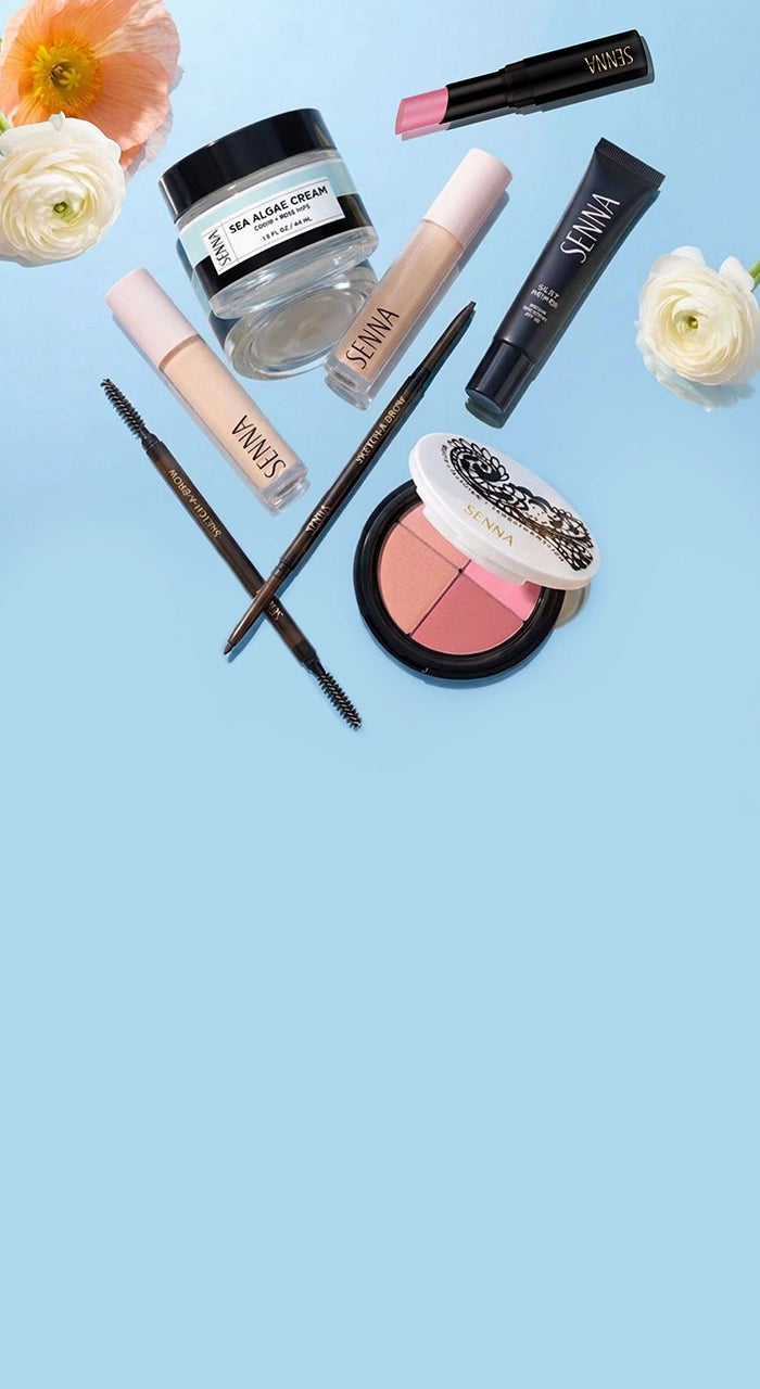 Makeup products including lip gloss, cream, and blush on a light blue background with flowers.