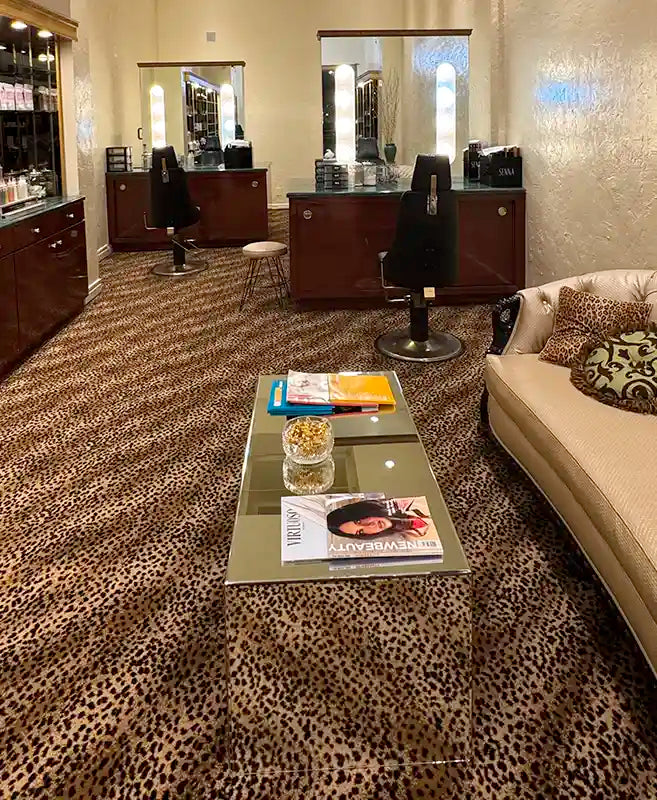 Makeup & Brow Studio Store with leopard print carpet, glass coffee table, and sofa.
