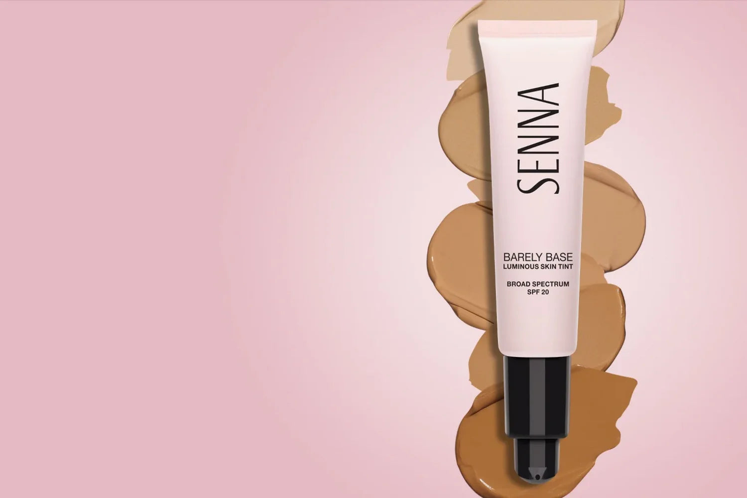 Senna Barely Base Luminous Skin Tint tube with foundation swatches on a pink background.