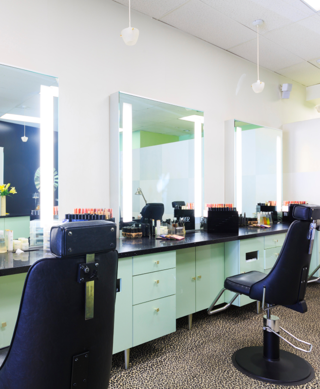 tarzana studio makeup stations with mirror and chairs and products on counter